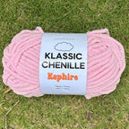 Pink skein of yarn with a label on grass