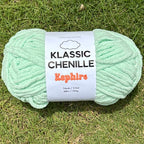 Light green skein of yarn with a label on grass