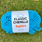 Blue skein of yarn with a label on grass