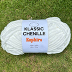Ball of yarn with a label on a grassy background